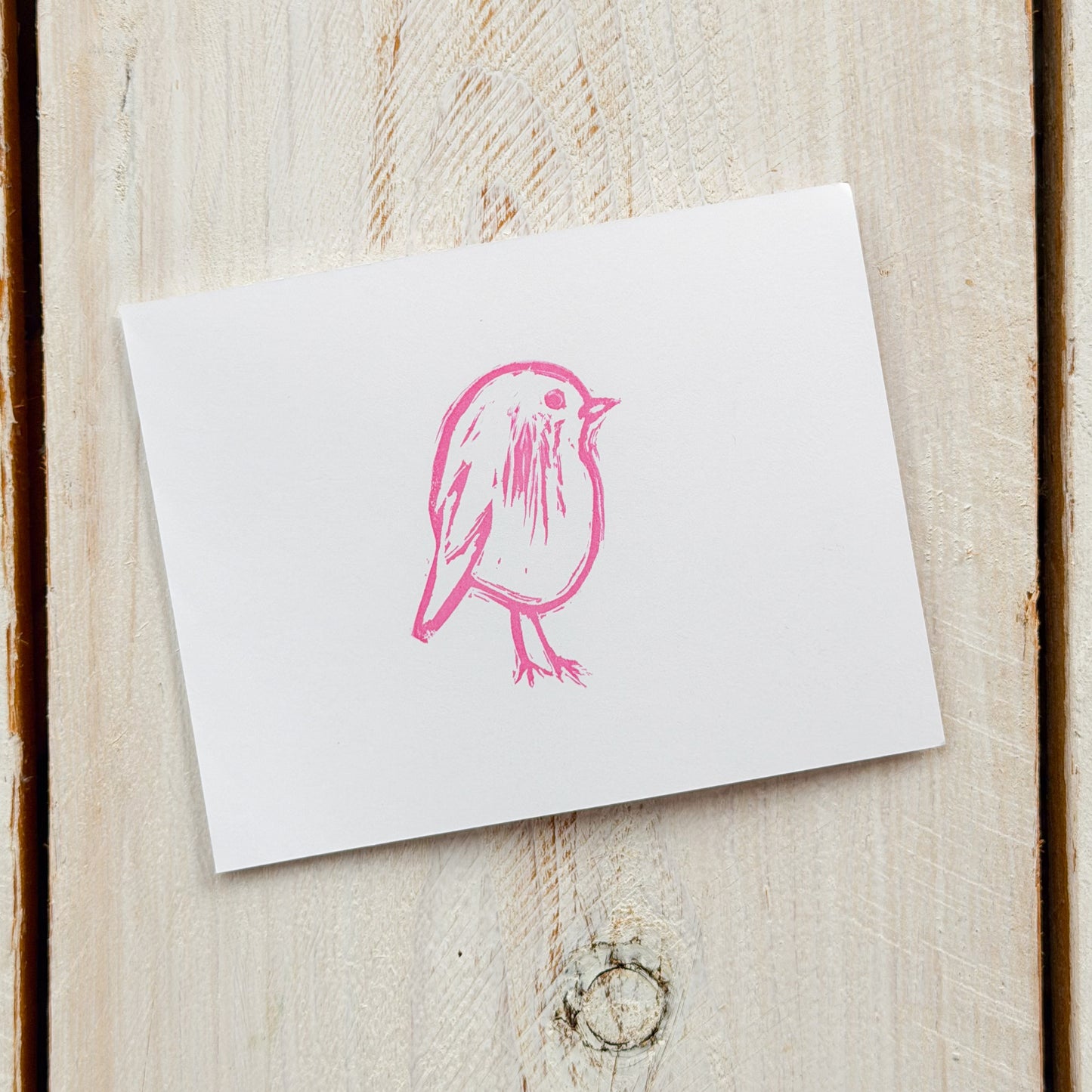 White card with a pink bird stamp on paper
