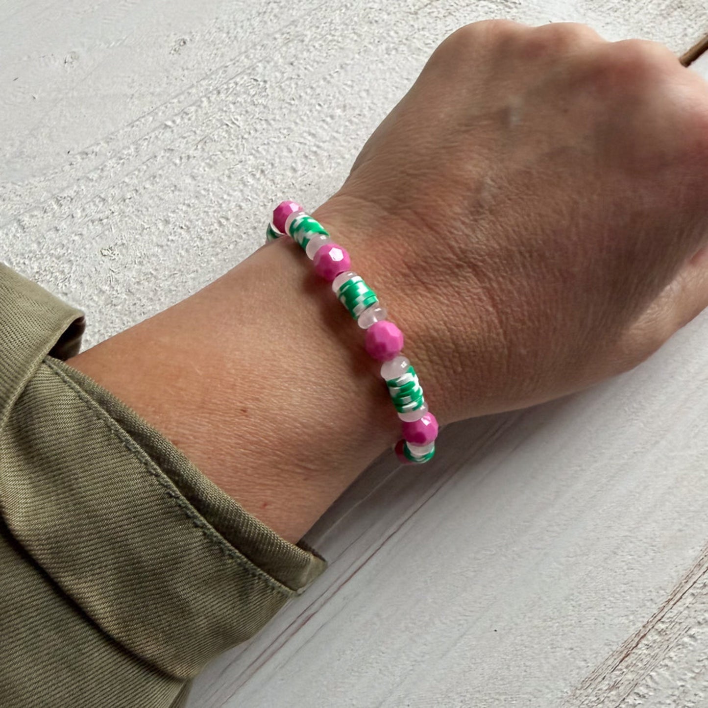 Hand wearing a colorful beaded bracelet 