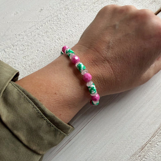 Hand wearing a colorful beaded bracelet 
