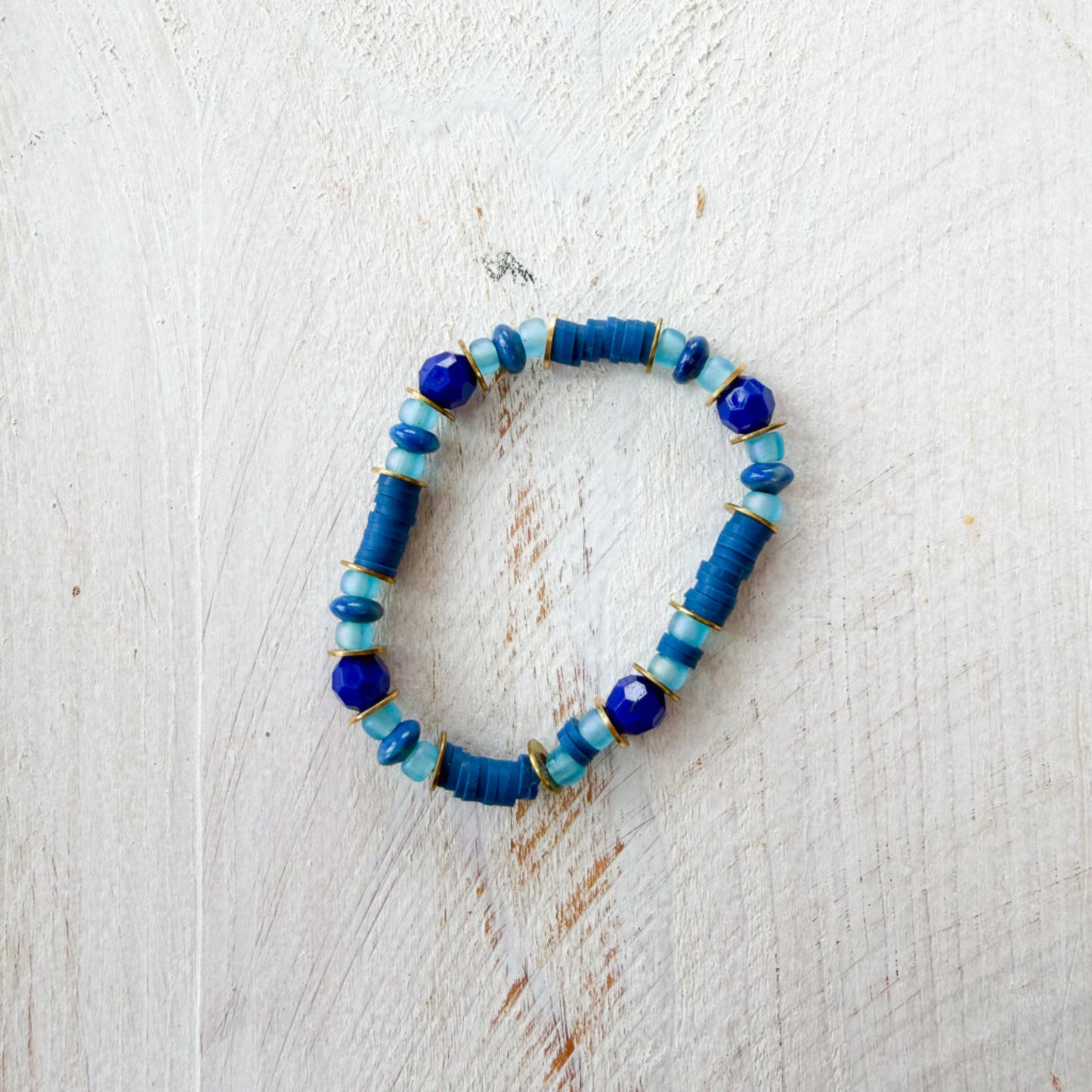 Blue beaded bracelet on a light wooden surface