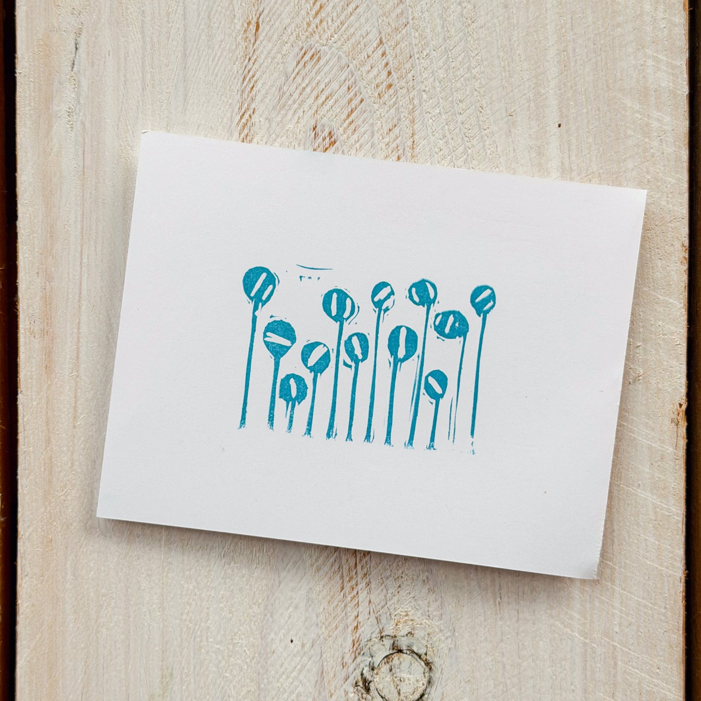 White card with blue floral design on paper