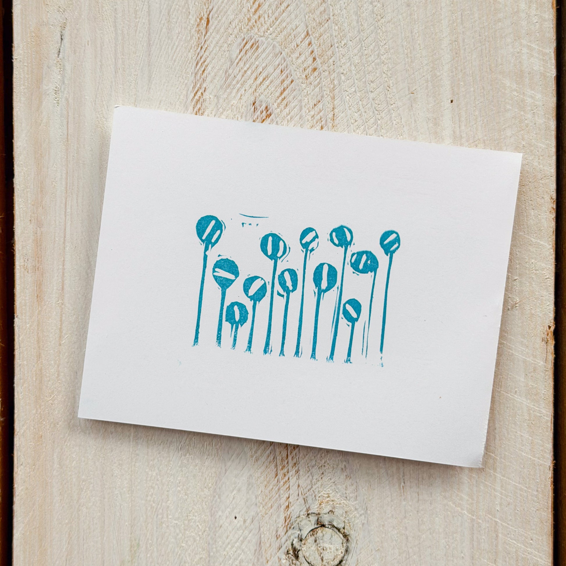 White card with blue floral design on paper